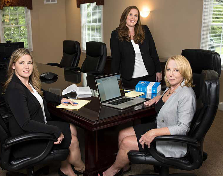 Three attorneys at a conference table